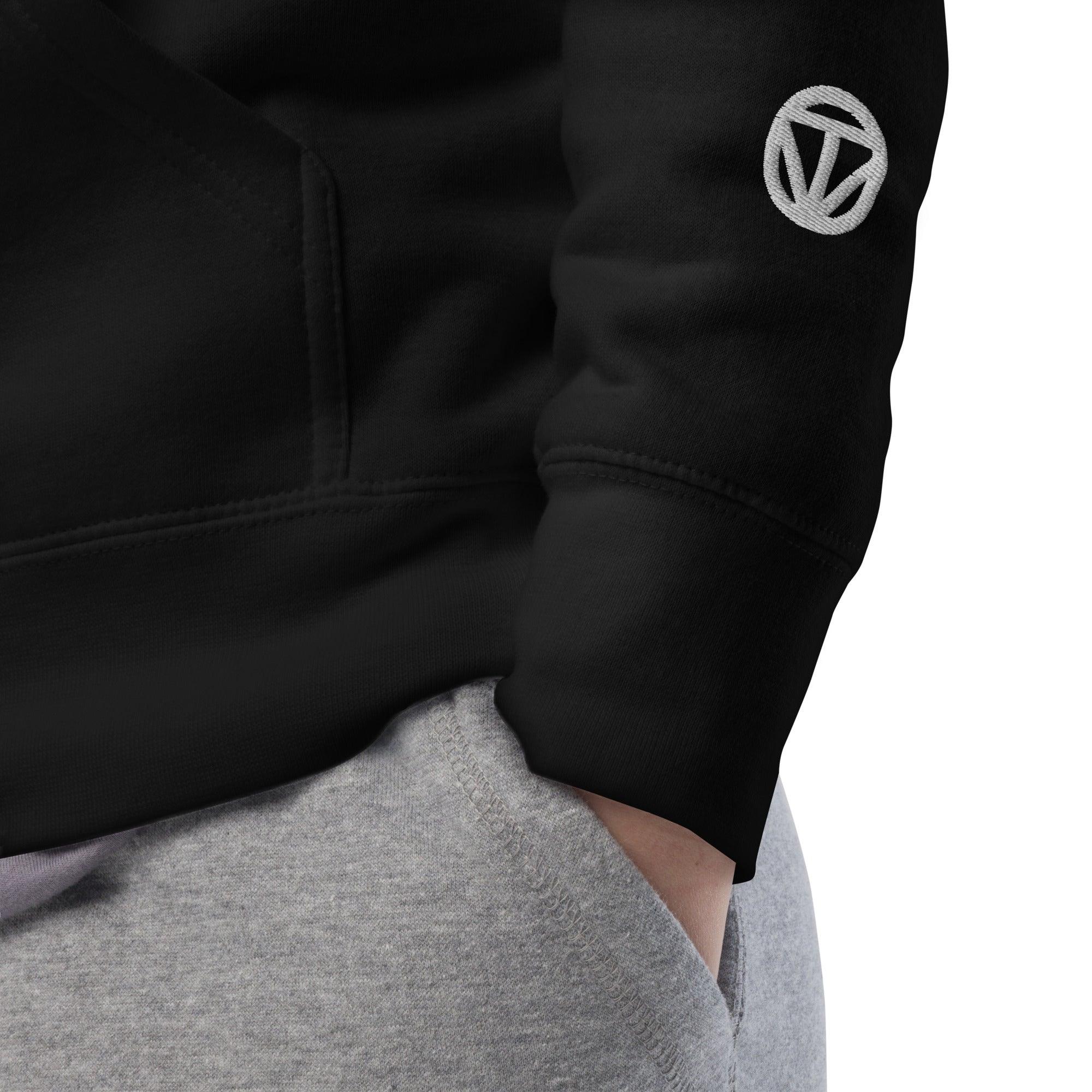 Schwarzer VIBES Hoodie mit weißem Logo auf Ärmel, graue Jogginghose, Detailansicht.